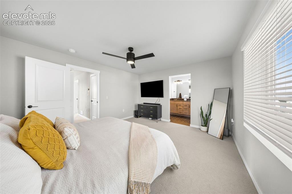 Image 30 of 48: View of the primary bedroom into the ensuite bath