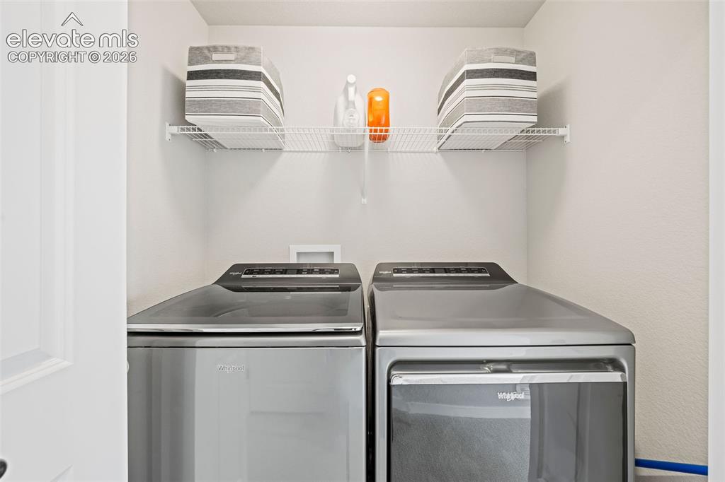 Image 33 of 48: The laundry area is perfectly located in the upstairs hallway between the t