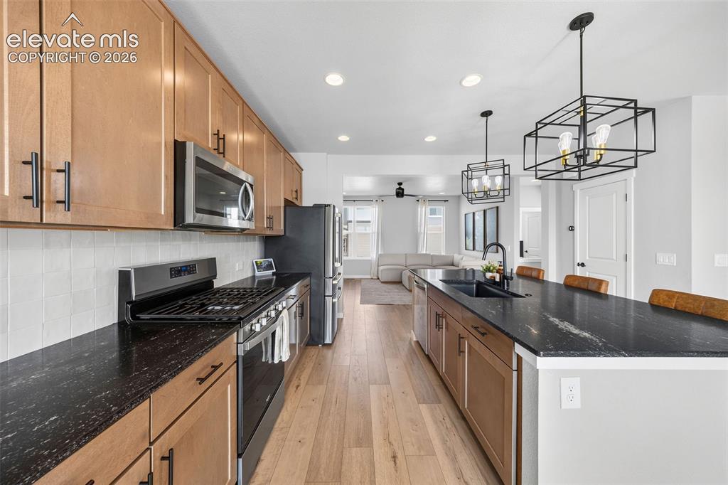 Image 4 of 48: Maple cabinetry, leathered granite countertops, stainless steel appliances 