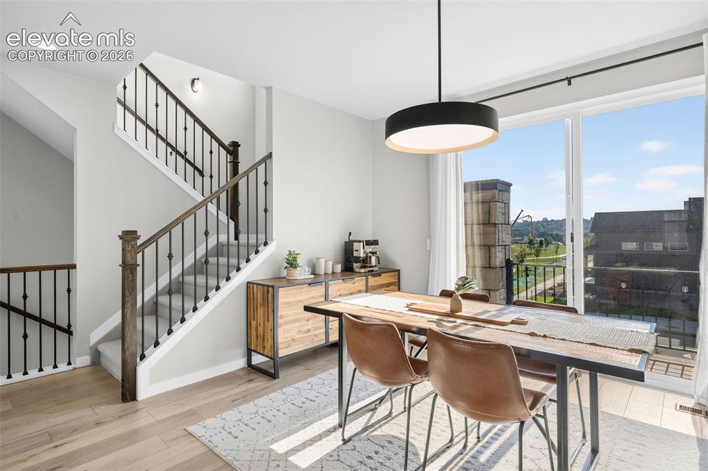 Image 8 of 48: The dining room opens to the private balcony and faces the park. Enjoy the 