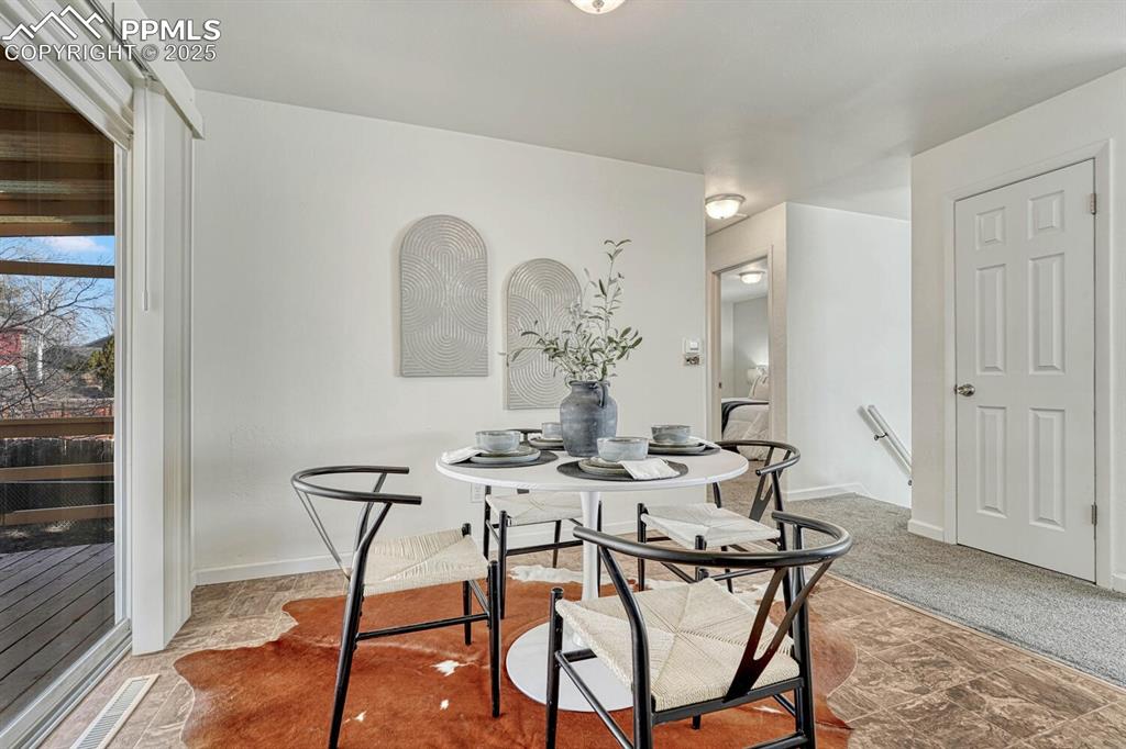 Image 10 of 43: Carpeted dining room featuring baseboards