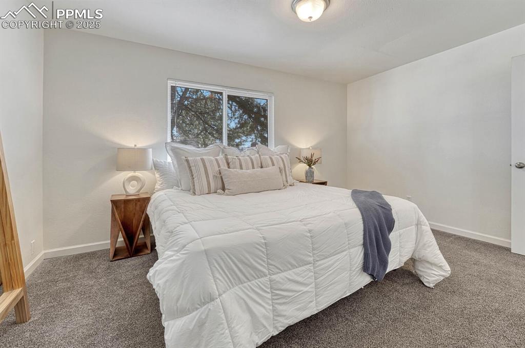 Image 18 of 43: Bedroom featuring baseboards and carpet floors