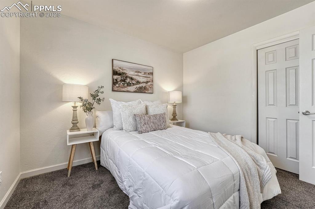 Image 22 of 43: Bedroom with carpet floors and baseboards