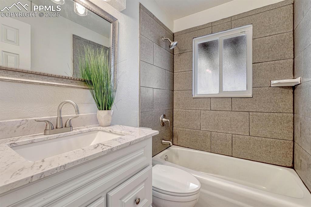 Image 24 of 43: Full bath featuring vanity and bathing tub / shower combination