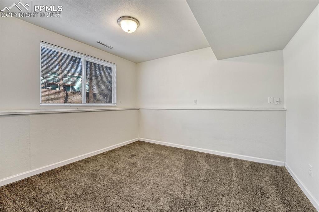 Image 28 of 43: Unfurnished room featuring carpet and baseboards