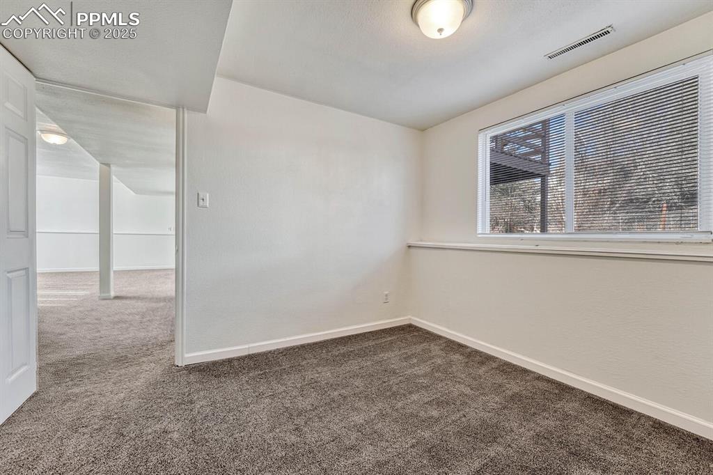 Image 32 of 43: Unfurnished room with carpet and baseboards