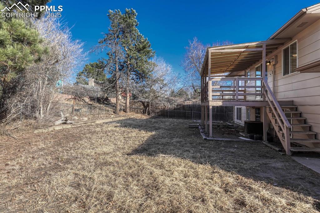 Image 37 of 43: View of yard featuring stairs and a wooden deck