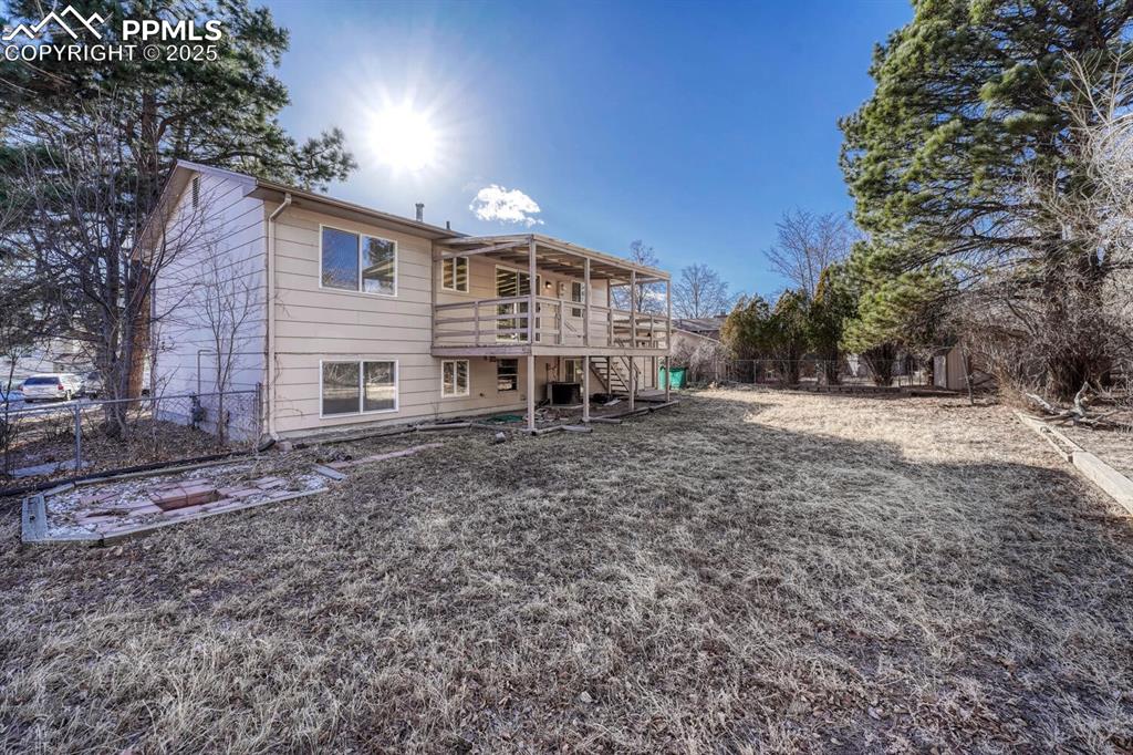 Image 39 of 43: Back of house featuring stairs, a deck, and a fenced backyard