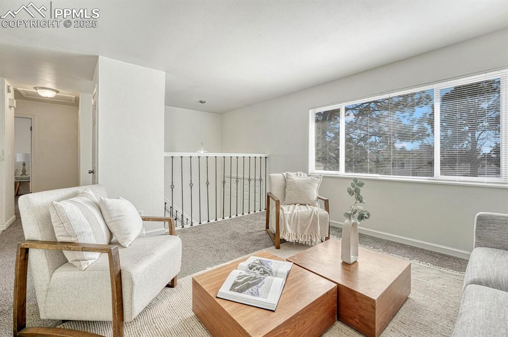 Image 6 of 43: Carpeted living room with baseboards