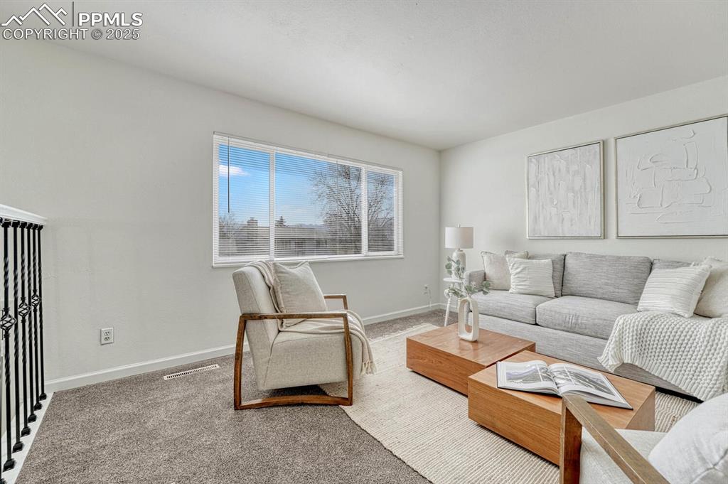 Image 7 of 43: Living room with carpet and baseboards