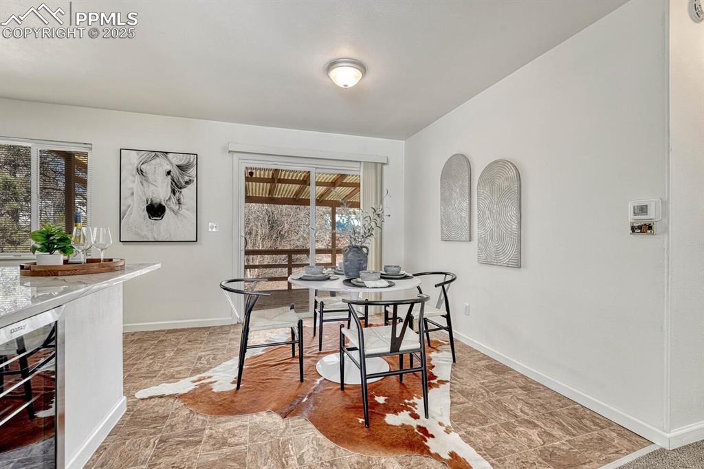 Image 8 of 43: Dining area with wine cooler and baseboards