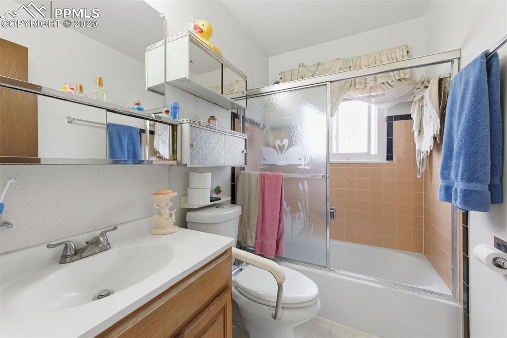 Image 15 of 24: Bathroom featuring a white vanity with an integrated sink, chrome faucet, a