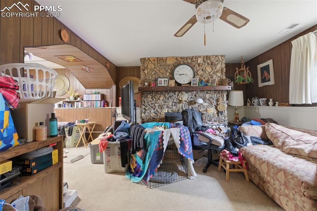 Image 18 of 24: Stone fireplace with a wood mantel