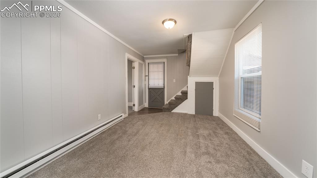 Image 10 of 14: Cottage house living room and dining room area showing front door
