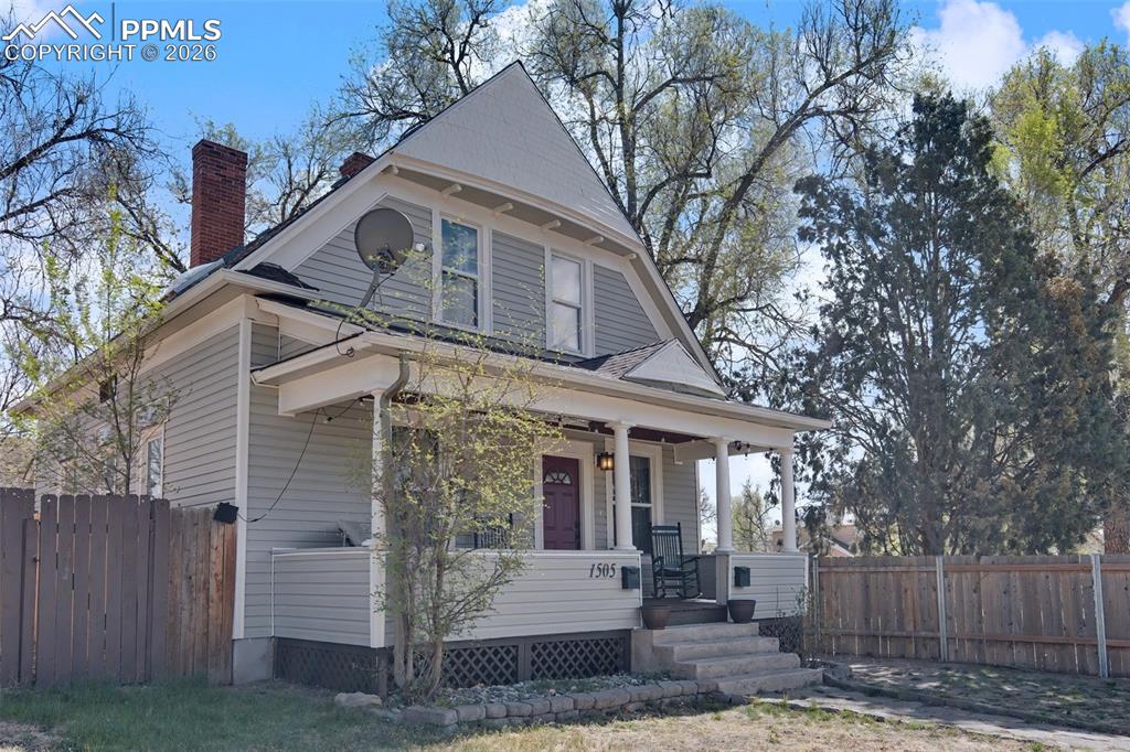 Image 2 of 14: Front/side of house showing side fence 