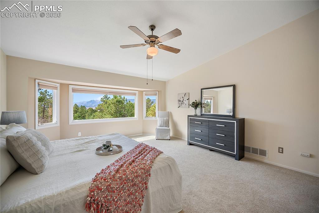 Image 26 of 49: Upstairs primary suite with vaulted ceilings and stunning mountain views.