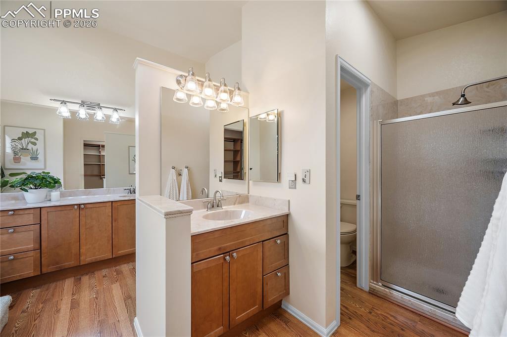 Image 28 of 49: Separate vanities, walk in shower