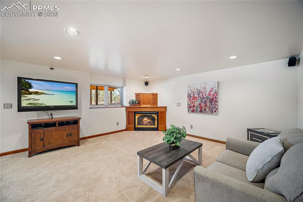 Image 36 of 49: Family room with corner gas fireplace.