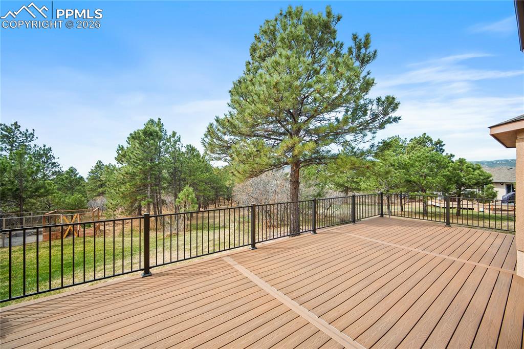 Image 43 of 49: Large deck overlooks back yard