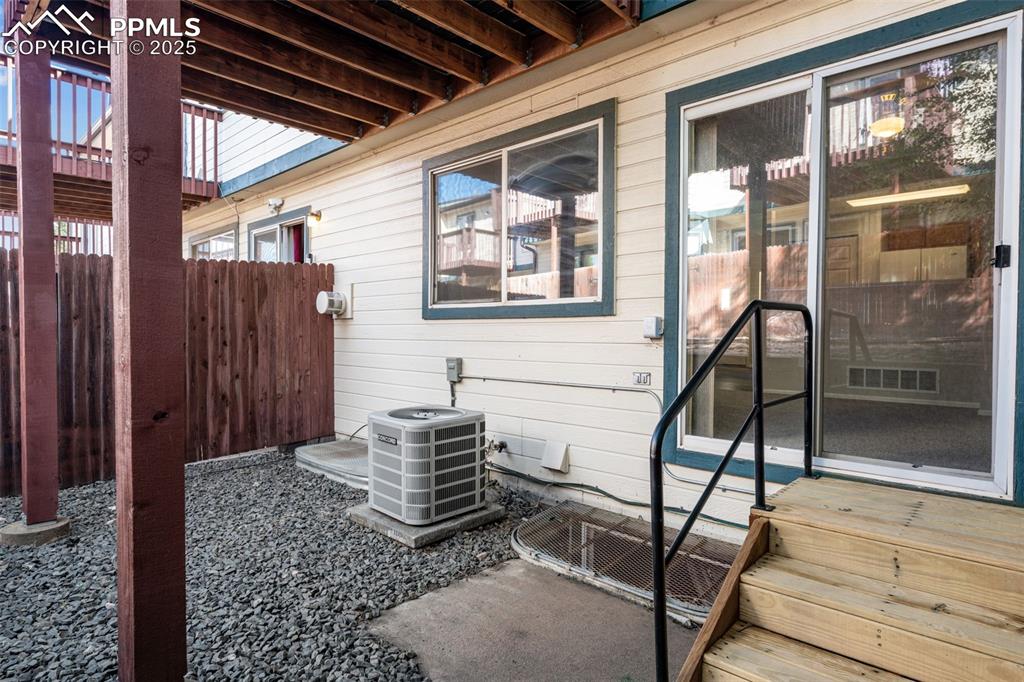 Image 21 of 30: View of side of home featuring a patio area and a cooling unit