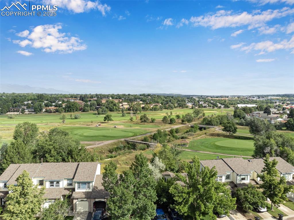 Image 29 of 30: Aerial perspective of suburban area featuring a tree filled landscape and a