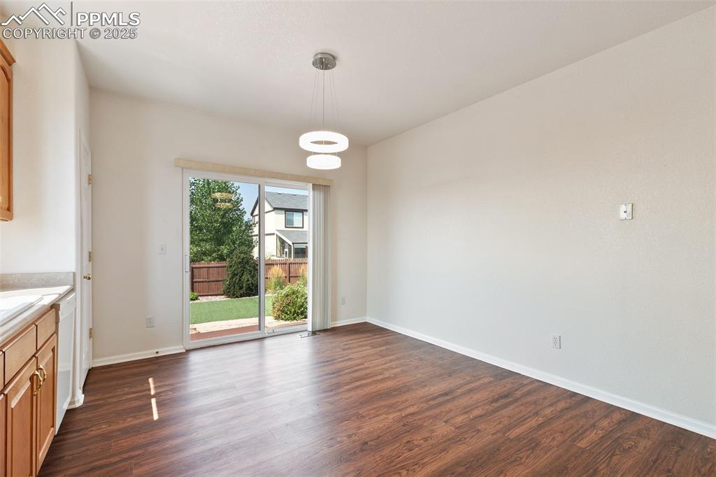 Image 12 of 28: Dining nook area in the kitchen with walk-out to the back yard.