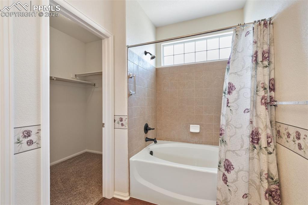Image 16 of 28: Large master bathroom with soaking tub and walk-in closet.