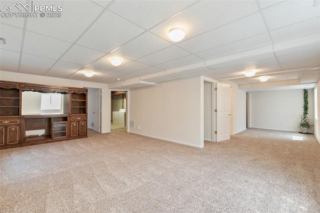 Image 20 of 28: Open room in basement is perfect for a family room or media room.