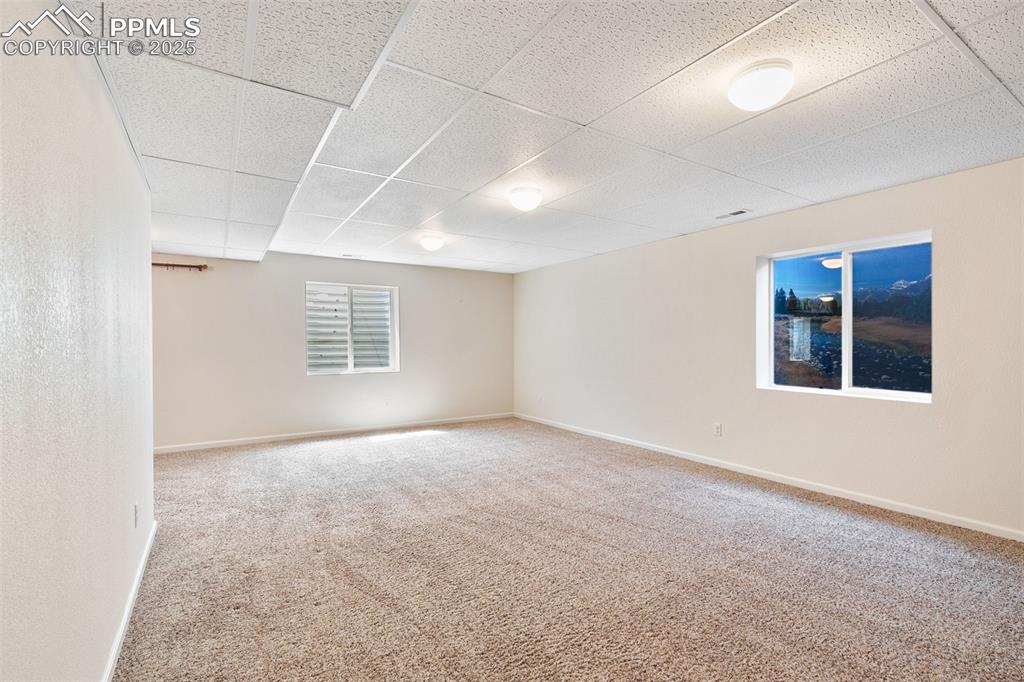 Image 21 of 28: Open room in basement is perfect for a family room or media room.