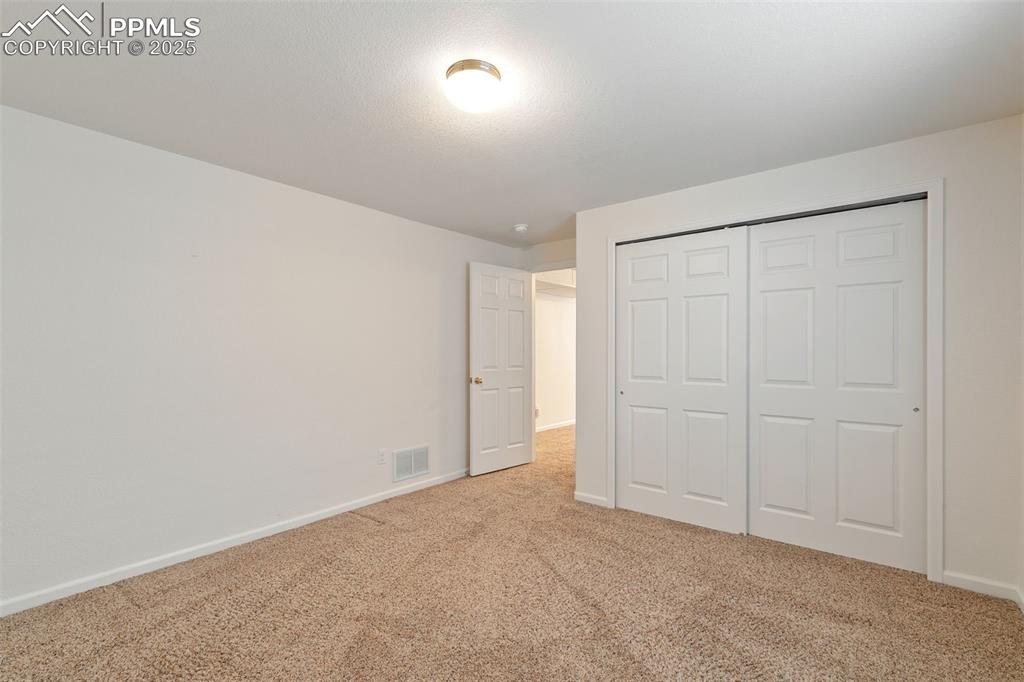 Image 24 of 28: Large basement bedroom.