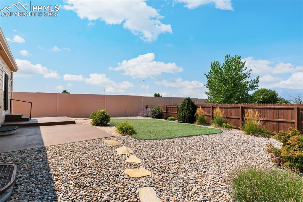Image 26 of 28: Large, beautiful xeriscaped yard.