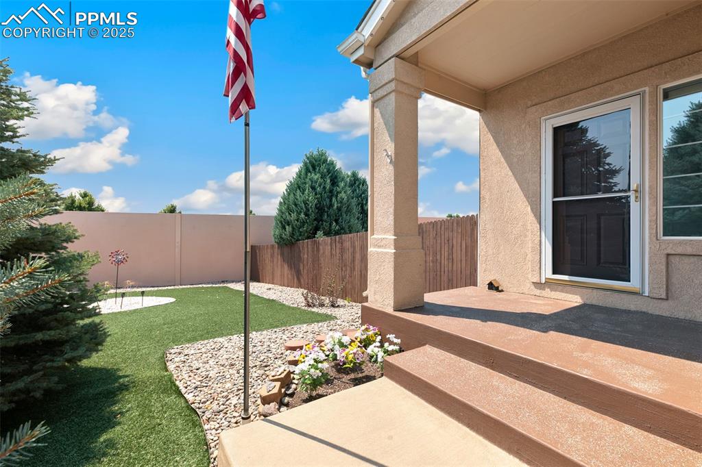 Image 3 of 28: Inviting front entrance to the home with xeriscaped yard.