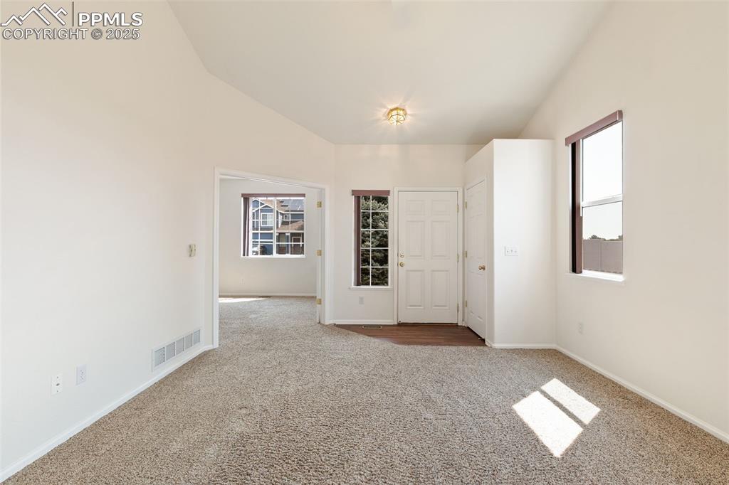 Image 6 of 28: Front entry is light and bright, with coat closet.