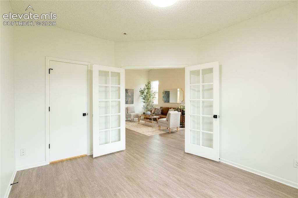 Image 18 of 26: Wood-finish flooring with white walls
