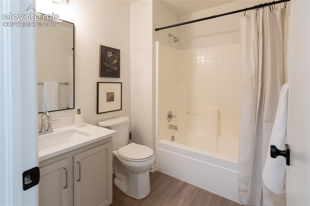 Image 20 of 26: Bathroom featuring a single vanity with light-toned cabinetry, quartz count