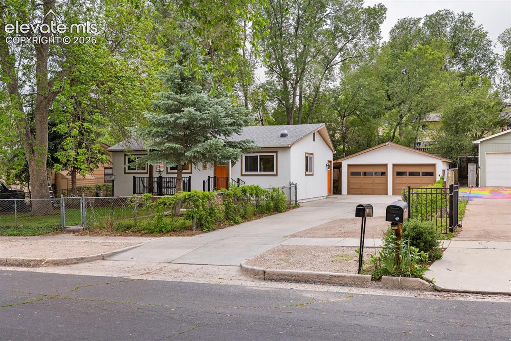Image 1 of 32: Stucco ranch-style home with finished basement and 2-car garage in low-traf