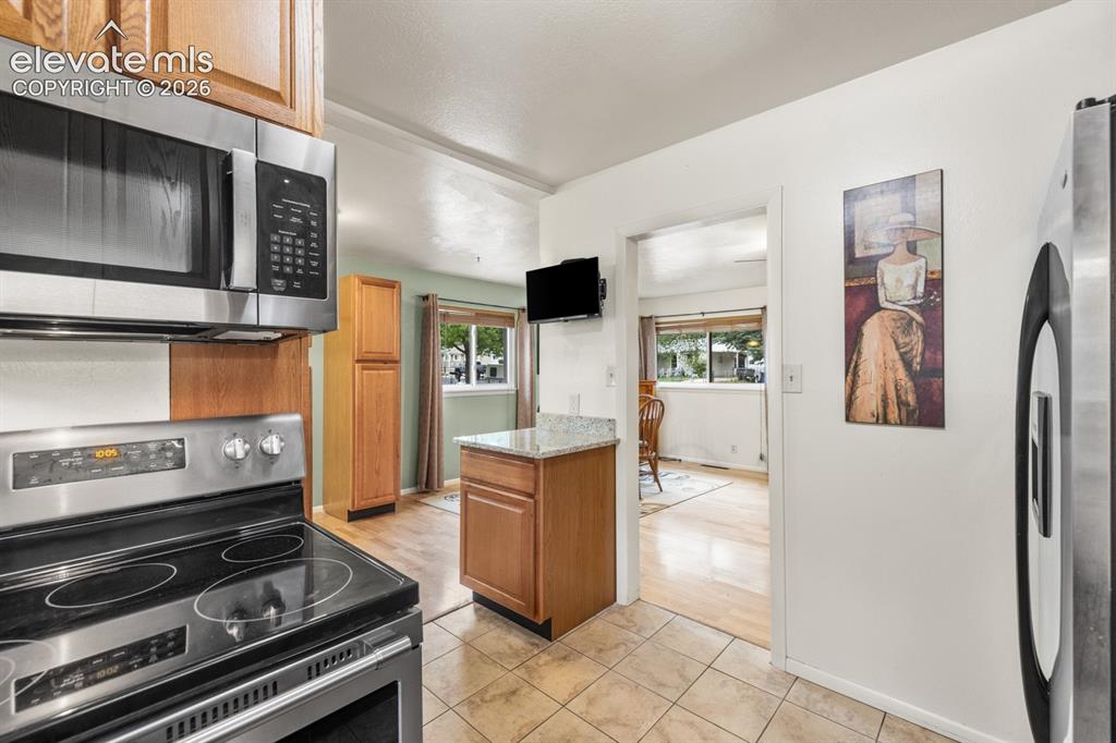 Image 11 of 32: Kitchen featuring stainless steel appliances including a range/oven and mic