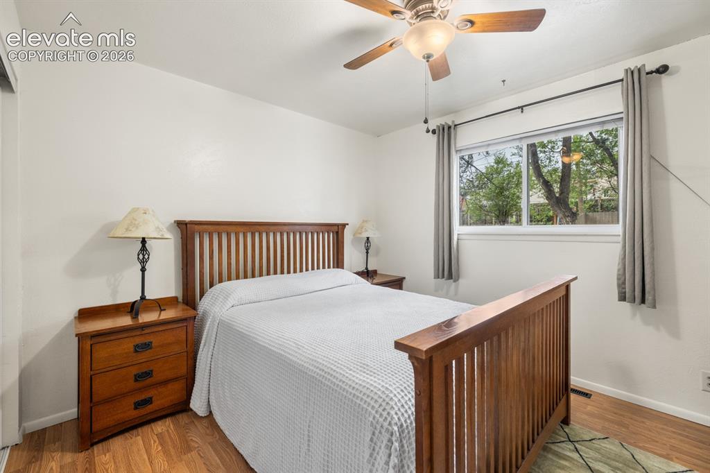 Image 13 of 32: Primary Bedroom Bedroom featuring wood-finish flooring, a ceiling fan with