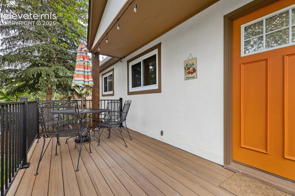 Image 7 of 32: New front deck is partially covered and features composite flooring and met