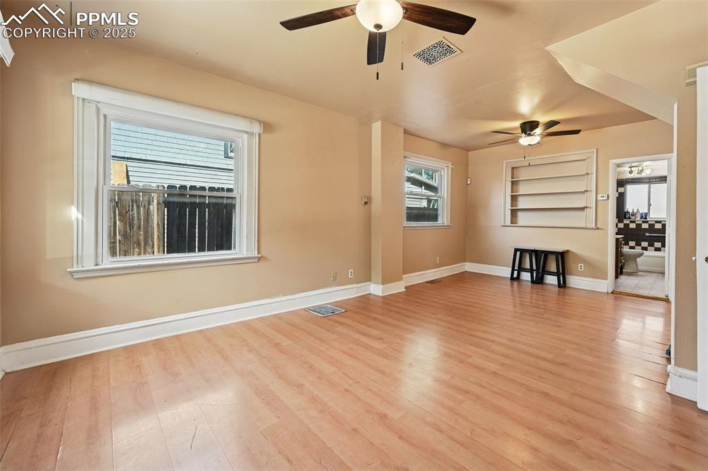 Image 11 of 24: Unfurnished living room featuring light wood-type flooring and ceiling fan