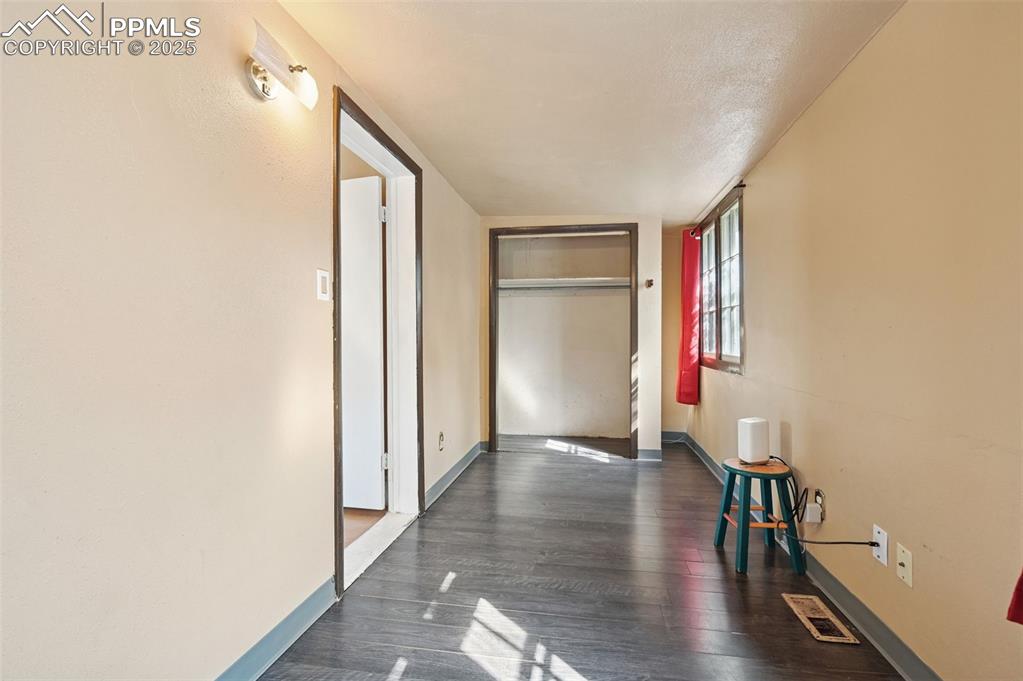 Image 14 of 24: Hall featuring baseboards and dark wood finished floors