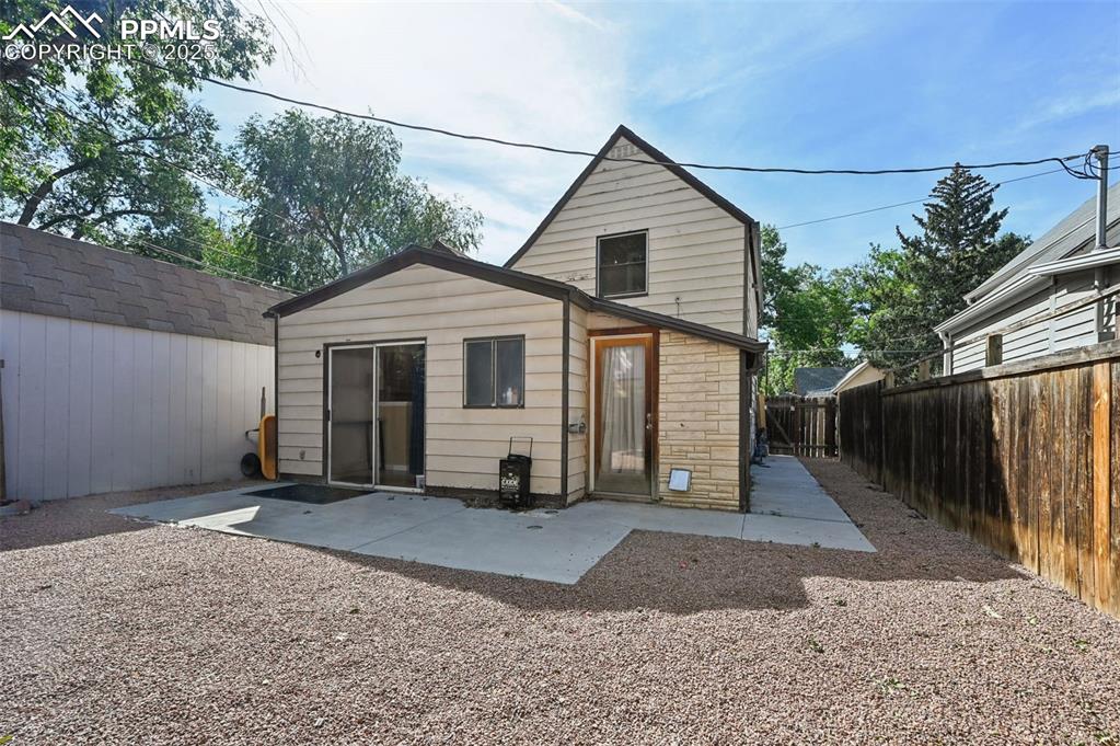 Image 23 of 24: Rear view of house featuring a patio and a fenced backyard