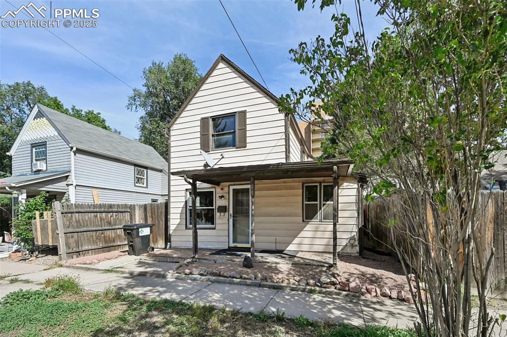 Image 3 of 24: View of front of property featuring a fenced backyard and a patio area