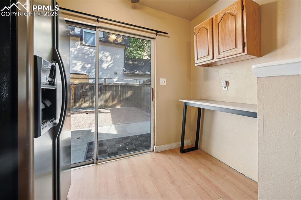 Image 5 of 24: Entryway with wood finished floors