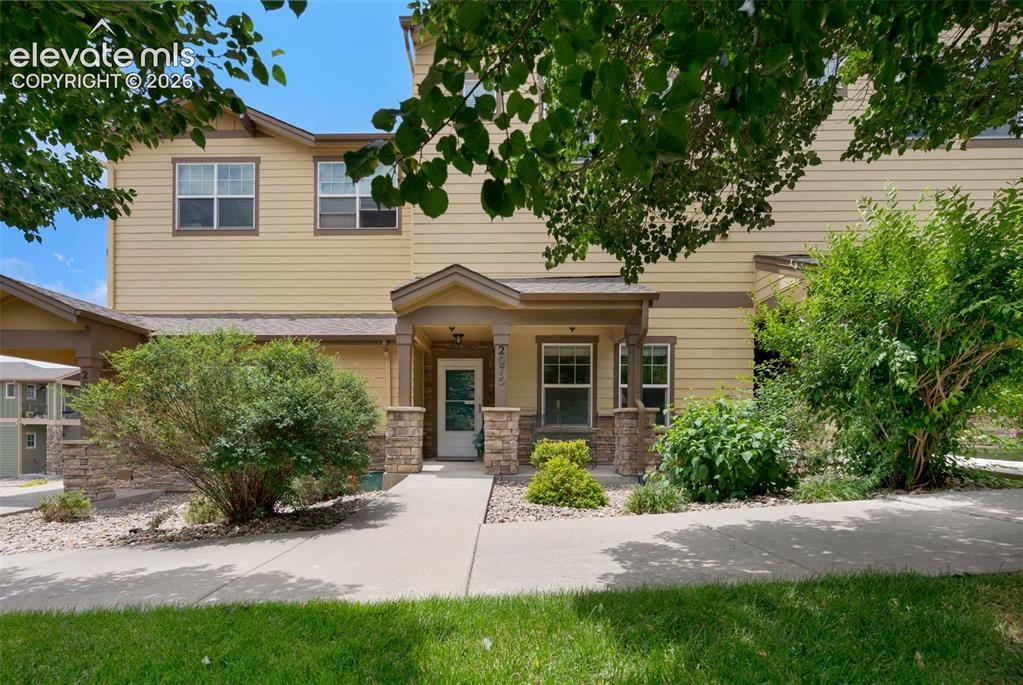 Image 1 of 28: Two-story exterior with light yellow siding and stone accents