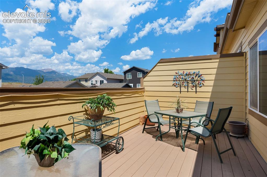 Image 14 of 28: Expansive outdoor deck featuring wood-finish flooring, privacy walls, and m