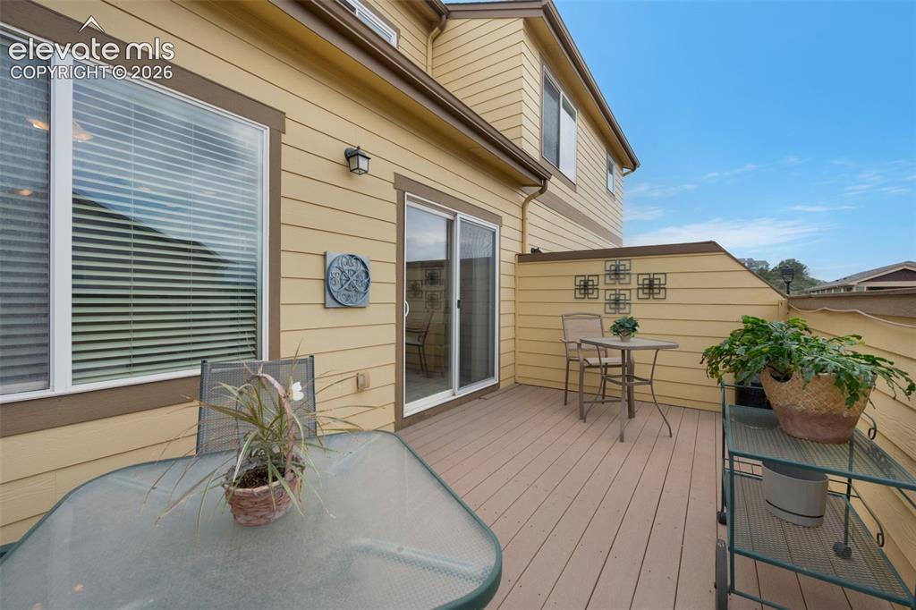 Image 15 of 28: Exterior deck featuring composite wood-finish flooring, a sliding glass doo