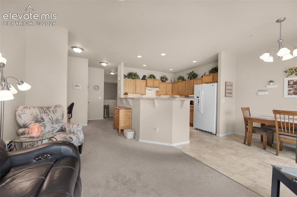 Image 9 of 28: Looking at the kitchen and eating area from the sitting room