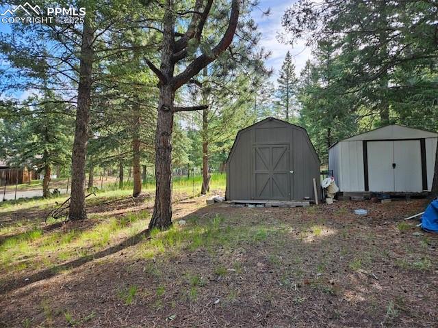 Image 2 of 6: View of shed with view of scattered trees
