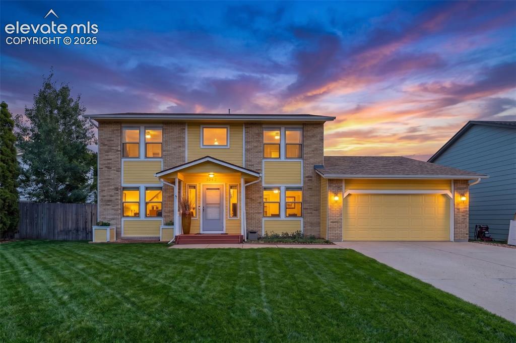 Image 1 of 49: Two-story home featuring a combination of brick and siding, an attached gar